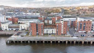an aerial view of a city with a pier at Dundee City Waterfront, 2 Bedroom 2 Bathroom Apartment - short walk to V and A, Bus & Train Stations in Dundee