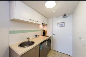 a kitchen with a sink and a counter top at Inner City Studio 501 in Toowoomba