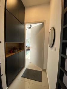 a hallway with a door to a room with a mirror at Netflix,Sauna,Jacuzzi,Karoke,Cat Friendly in Kuala Lumpur