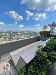 a bench on top of a balcony with a view of a city at Netflix,Sauna,Jacuzzi,Karoke,Cat Friendly in Kuala Lumpur