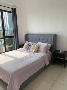 a bedroom with a large bed with a window at Netflix,Sauna,Jacuzzi,Karoke,Cat Friendly in Kuala Lumpur