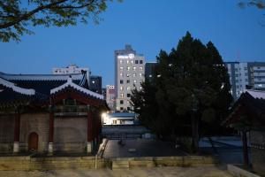 a building in a city with buildings in the background at Hotel DM in Seoul