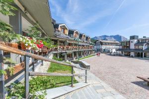 a street in a town with buildings and flowers at Sestriere Terrace Apt Few Steps From Ski - Happy Rentals in Sestriere
