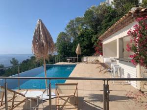 a villa with a swimming pool and a patio at Villa Paradise Vue Mer Golfe de Saint Tropez 8 couchages in Les Issambres