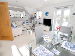 a living room with a glass table and a couch at Ocean Blue in Carbis Bay