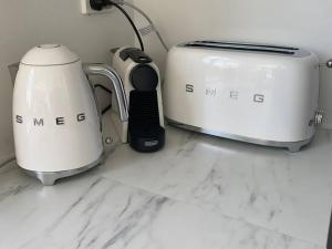 two toasters and a toaster on a kitchen counter at Spacious family home with Pool in Ascot in Brisbane