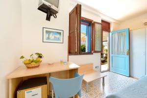 a dining room with a table and a blue chair at La Capannina in Procida