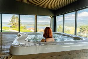a woman sitting in a hot tub in a house at Grande Vista Resort & Spa in Tsigov Chark