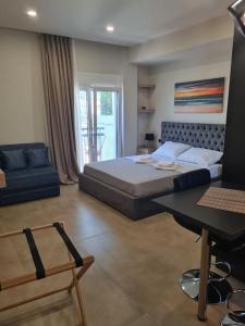 1 dormitorio con cama, mesa y sofá en Fay's luxury loft, en Volos