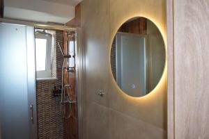 a bathroom with a shower and a mirror on the wall at Fay's luxury loft in Volos +47 photos