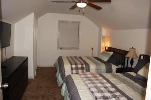 a hotel room with two beds and a flat screen tv at Perfect home for families, groups, and gatherings in Atlanta