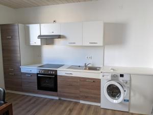 a kitchen with a washing machine and a washer at Monteurunterkunft Weiden by HausGruenerBaum in Weiden