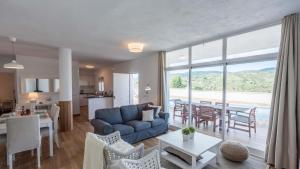 a living room with a blue couch and a table with chairs at Casa Rio Grande 2 Tolox by Ruralidays in Tolox