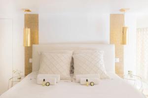 ein Schlafzimmer mit einem weißen Bett mit zwei weißen Kissen in der Unterkunft Luxury modern two bedroom duplex by Roland Garros in Paris