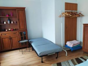 a room with a bed and a table and a shelf at Apartament z Widokiem na Śnieżkę in Jelenia Góra