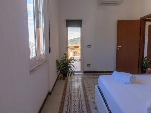 a white room with a bed and a window at The view in La Spezia