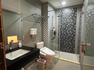 a bathroom with a shower and a sink and a toilet at Deng Mei Homestay in Hengshan