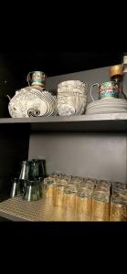 a shelf with jars and plates and bowls on it at Pristigia rabat in Rabat