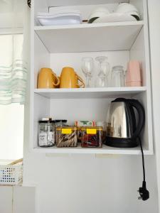 a cupboard filled with dishes and utensils at Cozzy homestyle in Nairobi