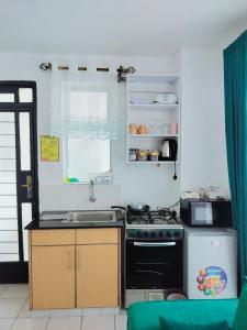 a kitchen with a stove and a sink at Cozzy homestyle in Nairobi
