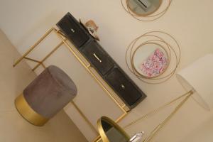 a room with a lamp and a mirror and a dresser at Miss Valentina-Modern Stone Villa in Aegina in Aegina Town