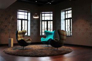 two chairs sitting in a room with windows at Motel One Edinburgh-Princes in Edinburgh