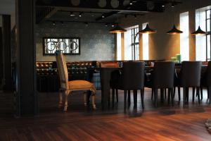 a dining room with a chair and a table with black chairs at Motel One Edinburgh-Princes in Edinburgh