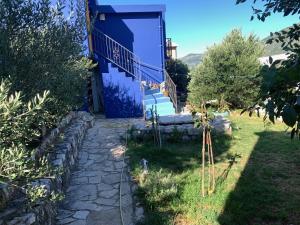 a house with a blue door and a stone path at U Villi BB2 Gornji Zalik bb in Mostar