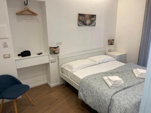 a small bedroom with a bed and a chair at B&B Vietri Centro 2 in Vietri sul Mare