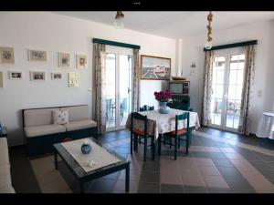 a living room with a table and a couch at Papoulias Rooms in Elafonisos