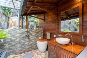 a bathroom with a sink and a bath tub at Pondok Carik Villa Manggis in Manggis