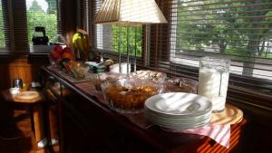 a kitchen counter with bowls and plates on a table at Sandilands House in Edinburgh