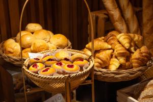 a bunch of baskets filled with bread and pastries at The Mandison Bangkok - Formerly Golden Tulip Mandison Suites in Bangkok +56 photos