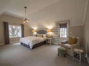a large bedroom with a bed and a chair at Oxford Healthcare Retreat in Johannesburg