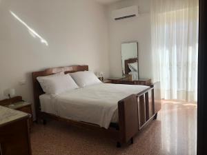 a bedroom with a large bed and a mirror at Regina in Ortona