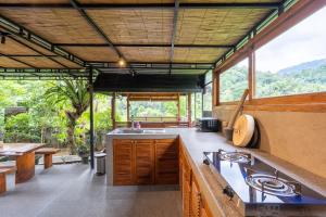 an open kitchen with a view of the mountains at Pondok Carik Villa Manggis in Manggis