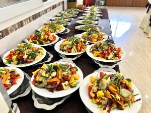 a row of plates of food on a table at Hương Toàn 2 Hotel in Phu Quoc +29 photos