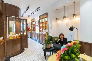 a woman sitting on a couch in the lobby of a store at Hương Toàn 2 Hotel in Phu Quoc
