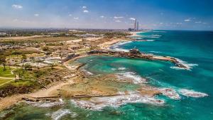 an aerial view of a beach and the ocean at Golden beach cottage by the sea in Caesarea