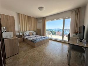 a bedroom with a bed and a large window at Вила Quiet Bay in Sozopol +261 photos