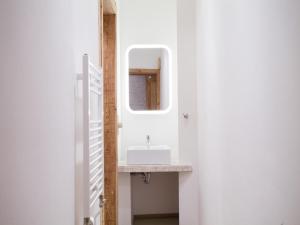 a bathroom with a sink and a mirror at Smart Appart Atelier Berlin in Berlin