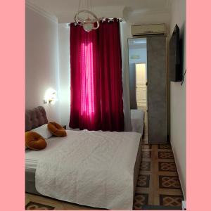 a bedroom with a bed and a red curtain at Rosa Italia Hotel Roma in Rome