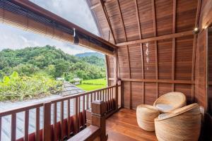 a room with a balcony with a view at Pondok Carik Villa in Manggis