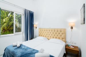 Postel nebo postele na pokoji v ubytování Helion Resort