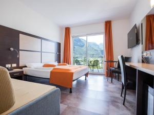 Postel nebo postele na pokoji v ubytování Hotel Benacus Panoramic