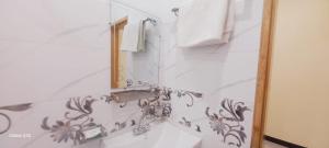 a bathroom with a sink and a mirror at Galiyat Inn Hotel, Balakot by LMC in Bālākot