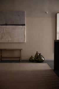 a room with two metal vases sitting on the floor at The Sanctuary Urban Retreat in Rome