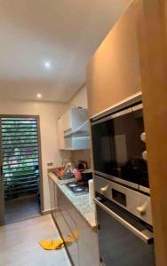 a kitchen with a stainless steel refrigerator and a counter at Superbe appartement à mohammadia in Mohammedia