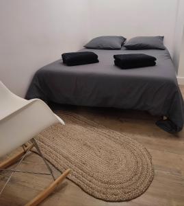 - un lit avec 2 oreillers et un tapis dans une chambre dans l'établissement L'Appart de Villard, à Villard-de-Lans