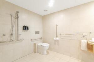 a bathroom with a toilet and a shower at Quiet Hotel Room in Mantra Salt Beach by uHoliday in Kingscliff